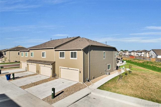 view of side of property featuring a garage and a yard