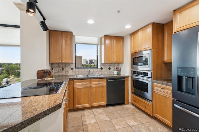 kitchen with black appliances, ceiling fan, tasteful backsplash, and sink