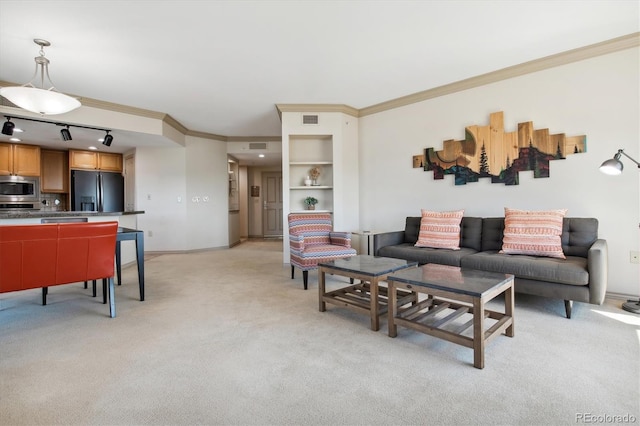 living room featuring crown molding, light colored carpet, and track lighting