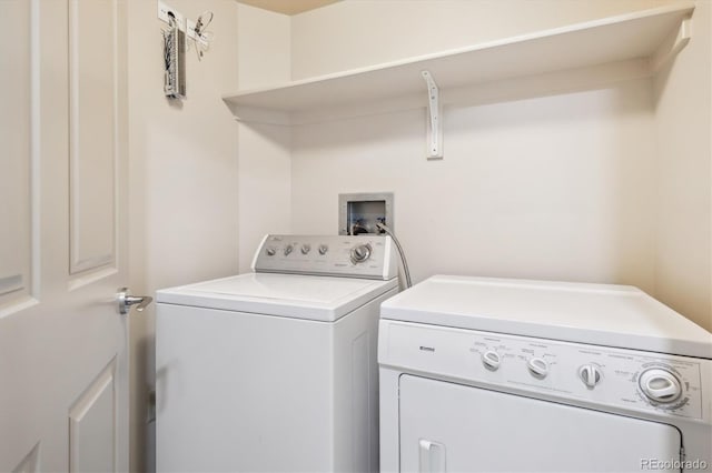 washroom with washing machine and clothes dryer