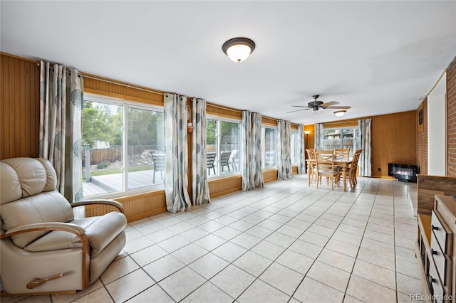 sunroom featuring wood walls and tile patterned floors
