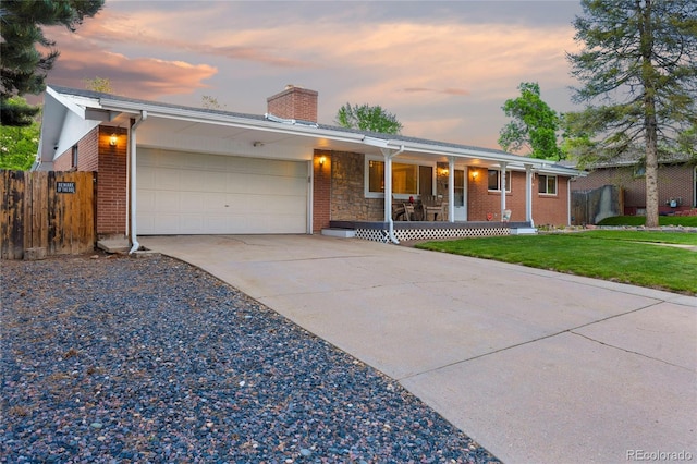 single story home with a porch, a garage, a chimney, driveway, and brick siding