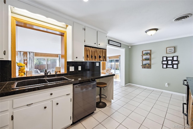 kitchen featuring stainless steel dishwasher, a sink, ornamental molding, backsplash, and white cabinets