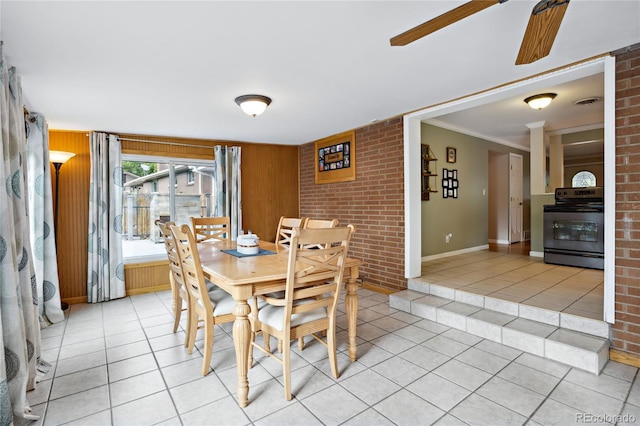 dining space featuring light tile patterned flooring, a ceiling fan, and baseboards