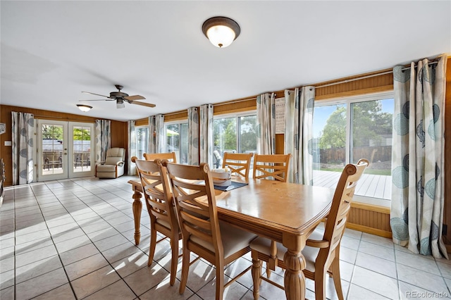 dining room with light tile patterned flooring, a ceiling fan, and french doors