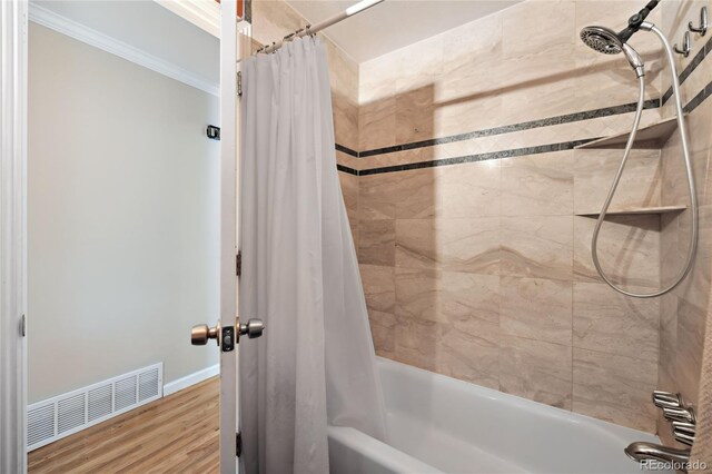 full bathroom featuring ornamental molding, shower / tub combo, wood finished floors, and baseboards
