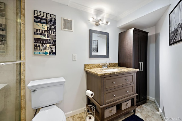 bathroom featuring toilet, crown molding, baseboards, vanity, and tiled shower