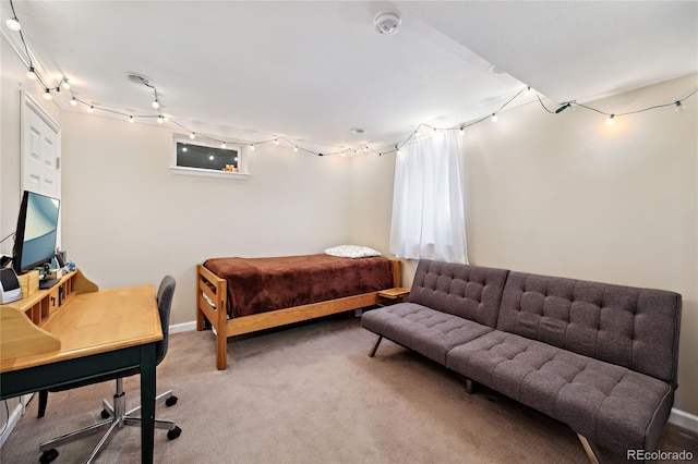 carpeted bedroom featuring baseboards
