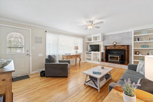 6013 S Logan St, Centennial, CO 80121 - living area featuring a ceiling fan, plenty of natural light, light wood finished floors, ornamental molding, and built in shelves