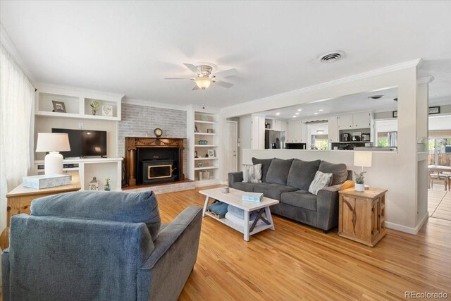 6013 S Logan St, Centennial, CO 80121 - living room featuring light wood finished floors, a ceiling fan, crown molding, built in features, and baseboards