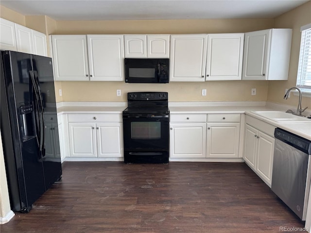 kitchen featuring dark wood finished floors, light countertops, white cabinetry, a sink, and black appliances