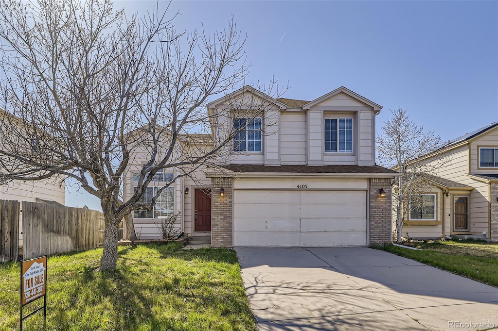 4105 N Dunkirk Ct, Denver, CO 80249 - traditional-style home featuring concrete driveway, an attached garage, brick siding, fence, and a shingled roof