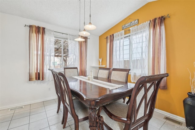 dining room with lofted ceiling, visible vents, and a wealth of natural light