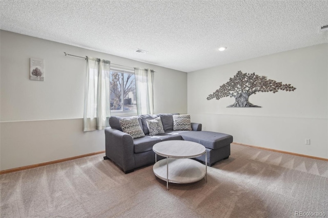 carpeted living area featuring visible vents, a textured ceiling, and baseboards