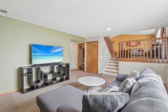 carpeted living area with stairs, a textured ceiling, visible vents, and baseboards