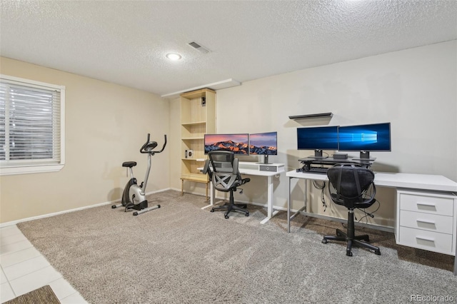 office space with visible vents, a textured ceiling, and baseboards