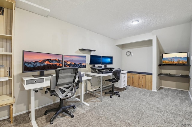 office space with baseboards, a textured ceiling, and carpet flooring