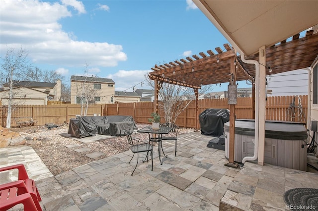 view of patio / terrace with a hot tub, a grill, a pergola, and a fenced backyard