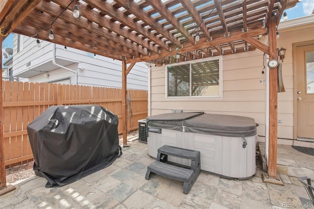 view of patio with a hot tub, a grill, fence, cooling unit, and a pergola