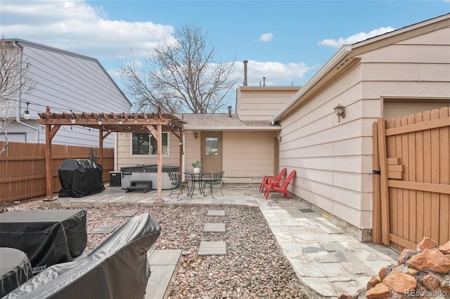 view of patio with a hot tub, a pergola, grilling area, and a fenced backyard