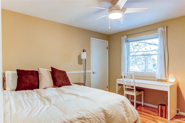 bedroom with light hardwood / wood-style flooring and ceiling fan