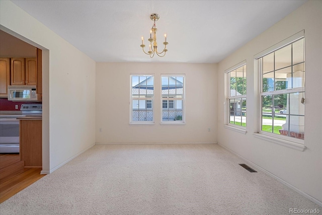 7912 S Buchanan Way, Aurora, CO 80016 - unfurnished dining area featuring a chandelier and light colored carpet