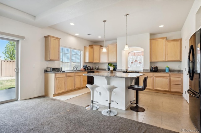 19047 Randolph Pl, Denver, CO 80249 - kitchen featuring freestanding refrigerator, recessed lighting, a kitchen bar, and light brown cabinetry