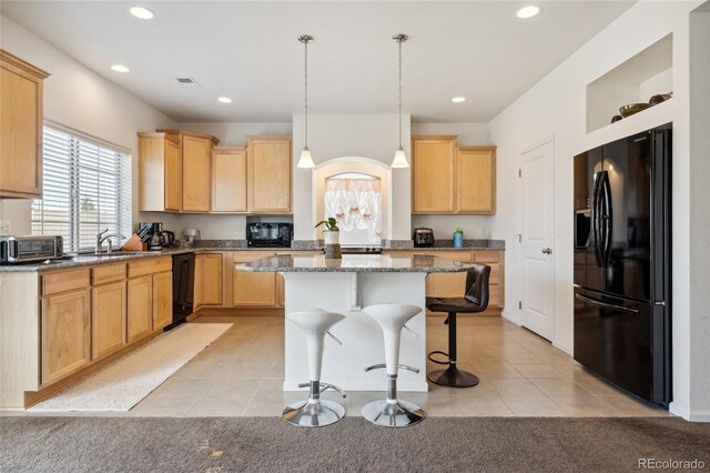 19047 Randolph Pl, Denver, CO 80249 - kitchen with a center island, a kitchen breakfast bar, black appliances, and recessed lighting