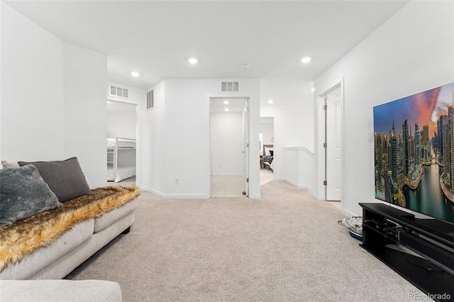 carpeted living area with baseboards, visible vents, and recessed lighting