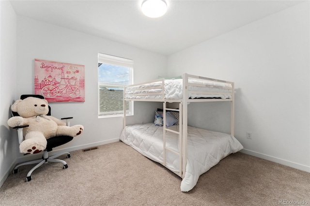 bedroom with carpet, visible vents, and baseboards