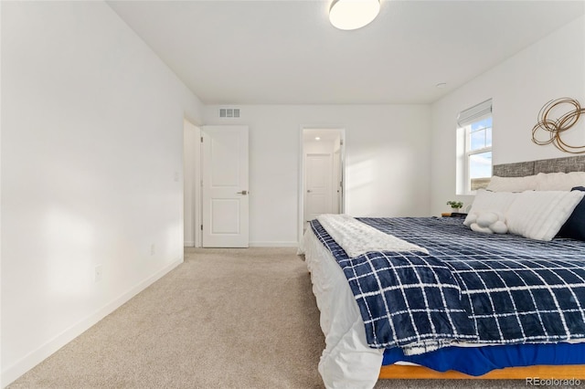 bedroom with carpet floors, visible vents, and baseboards