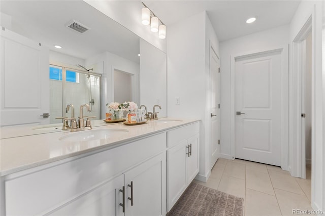 full bathroom with a sink, visible vents, and tile patterned floors