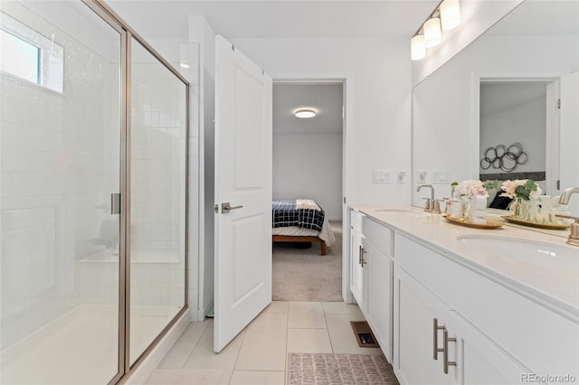 full bath featuring a stall shower, tile patterned flooring, connected bathroom, and a sink