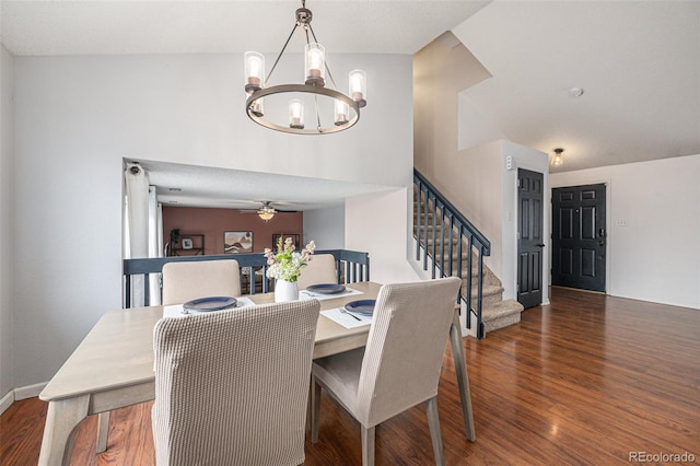 dining space featuring stairs, ceiling fan with notable chandelier, wood finished floors, and baseboards