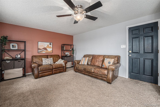 carpeted living area featuring ceiling fan and a textured ceiling