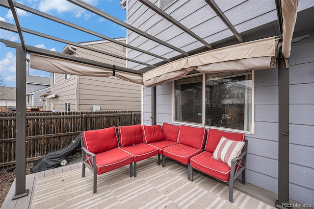 wooden deck with outdoor lounge area, fence, and a pergola