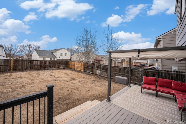 wooden terrace featuring a fenced backyard