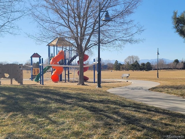 community playground featuring a lawn and a mountain view