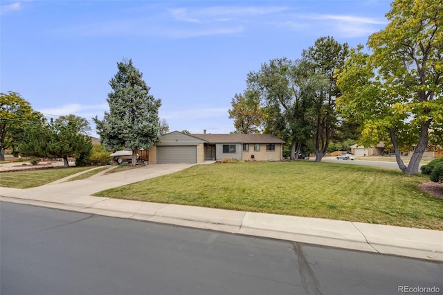 single story home with a front lawn, a garage, and driveway