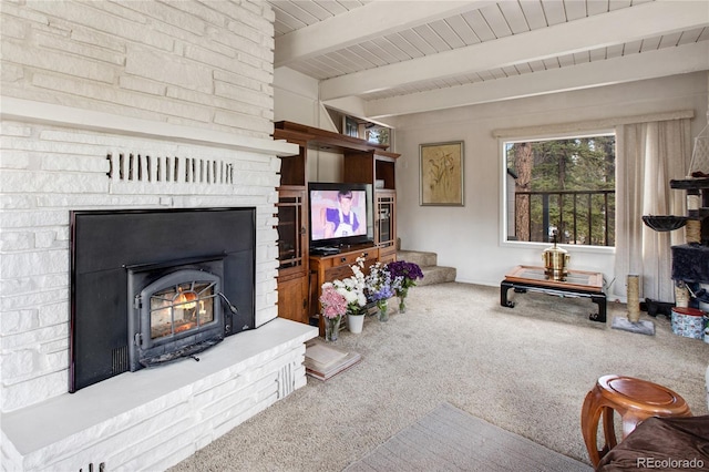 living room featuring carpet and beamed ceiling