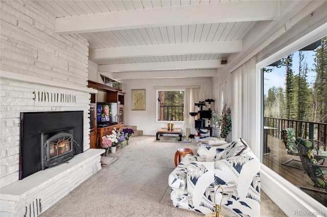 carpeted living room featuring beamed ceiling