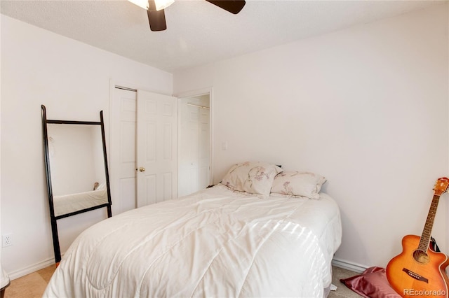 bedroom with light carpet, a textured ceiling, and ceiling fan