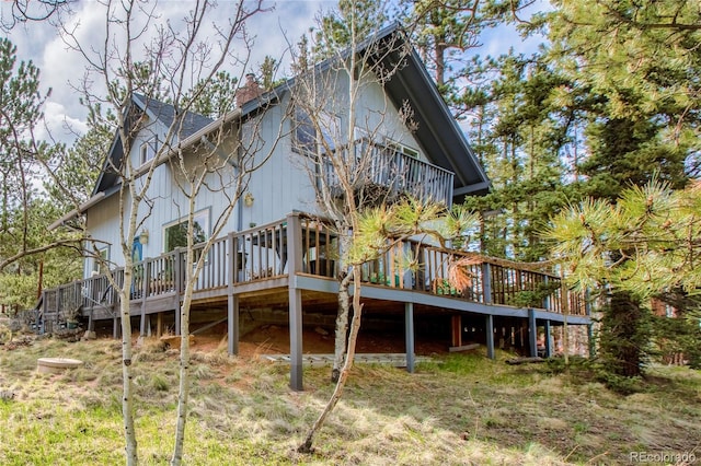 rear view of property featuring a wooden deck