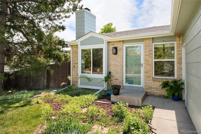 9376 W Wagon Trail Cir, Littleton, CO 80123 - view of exterior entry with brick siding and a chimney