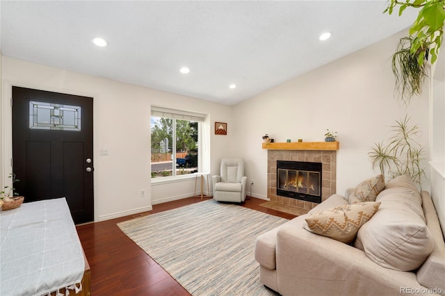 9376 W Wagon Trail Cir, Littleton, CO 80123 - living room featuring a fireplace, wood finished floors, lofted ceiling, recessed lighting, and baseboards