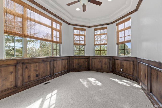 unfurnished sunroom featuring ceiling fan and a tray ceiling