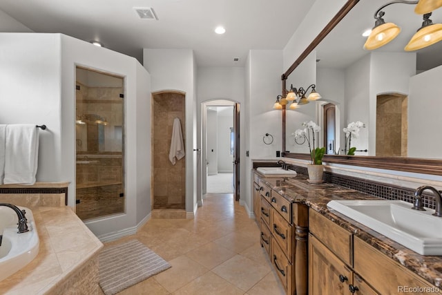 bathroom with shower with separate bathtub, vanity, and tile patterned floors