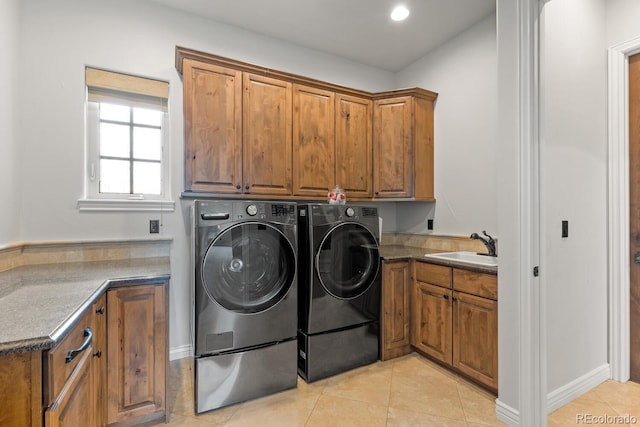 clothes washing area featuring cabinets, separate washer and dryer, sink, and light tile patterned floors