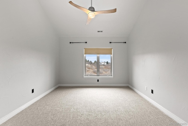 carpeted spare room with vaulted ceiling and ceiling fan