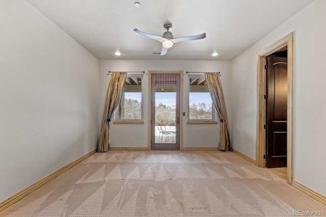 carpeted spare room with ceiling fan